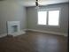 Bright living room featuring new flooring, a decorative fireplace, and large windows at 1131 Indale Sw Pl, Atlanta, GA 30310