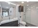 Bright bathroom with glass-enclosed shower, modern vanity, mirror and wall cabinet at 1418 Summit North Ne Dr # 1418, Atlanta, GA 30324