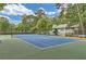 Community tennis court with well-maintained surface, net, and surrounding landscape at 1418 Summit North Ne Dr # 1418, Atlanta, GA 30324