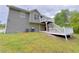 Exterior view of the home with a two story deck overlooking a well maintained backyard at 3342 Windpointe Ct, Buford, GA 30519