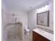 Well-lit bathroom featuring a tiled shower with a glass door, modern vanity, and neutral color palette at 3342 Windpointe Ct, Buford, GA 30519