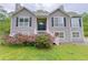 Charming two-story home featuring lush pink rhododendrons, gray siding, and black window shutters at 3342 Windpointe Ct, Buford, GA 30519