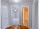 Hallway leads to a bedroom and bathroom featuring gleaming hardwood floors at 3342 Windpointe Ct, Buford, GA 30519