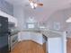 Modern kitchen with stainless steel appliances, ample cabinet space, and granite countertops overlooking living area at 3342 Windpointe Ct, Buford, GA 30519
