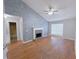 Bright and airy living room featuring a fireplace, accent wall, and hardwood floors at 3342 Windpointe Ct, Buford, GA 30519