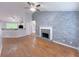 Open concept space with fireplace, accent wall, hardwood floors, neutral paint, and great natural light at 3342 Windpointe Ct, Buford, GA 30519