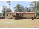 Spacious backyard with mature trees, a deck, and large grass area at 3814 Lamar Way, Snellville, GA 30039