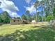 Large backyard area with mature trees and play structure at 3814 Lamar Way, Snellville, GA 30039