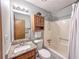 This bathroom is equipped with a tub shower and wooden vanity at 3814 Lamar Way, Snellville, GA 30039