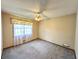 A bright bedroom with carpet, a ceiling fan, and a window with floral valance at 3814 Lamar Way, Snellville, GA 30039