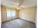 Bedroom with floral window valance, carpet flooring and neutral colored walls and ceiling fan at 3814 Lamar Way, Snellville, GA 30039