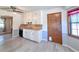 Bright kitchen with white cabinets, wood countertops, and modern gray flooring and a 'Kitchen' sign on the door at 3814 Lamar Way, Snellville, GA 30039
