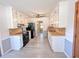 Kitchen featuring white cabinets, black appliances, wood countertops, modern gray flooring and ceiling fan at 3814 Lamar Way, Snellville, GA 30039