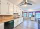 Eat in kitchen with white cabinets, butcher block countertops, wood floors, and a stainless steel sink at 3814 Lamar Way, Snellville, GA 30039