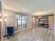 Open living room featuring a large window, a light fixture, wood floors, and space for a home office at 3814 Lamar Way, Snellville, GA 30039