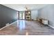 Open living room with hardwood floors, stone fireplace, light grey walls and access to the backyard at 3814 Lamar Way, Snellville, GA 30039