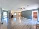 Spacious living room featuring modern flooring, ceiling fan, light grey walls and two large windows at 3814 Lamar Way, Snellville, GA 30039