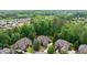 Aerial view of a neighborhood showcasing well-maintained homes surrounded by lush greenery at 5475 Copper Creek Pass, Cumming, GA 30040