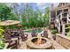Expansive backyard featuring an outdoor fireplace, dining set, and a gunite pool and spa at 5475 Copper Creek Pass, Cumming, GA 30040