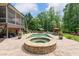 Backyard patio with outdoor spa, pool, lush lawn, and a screened porch on a brick two-story home at 5475 Copper Creek Pass, Cumming, GA 30040
