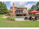 Expansive backyard features include a pool, stone-paver patio, lush lawn, and well-maintained landscaping at 5475 Copper Creek Pass, Cumming, GA 30040