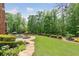 A beautiful backyard features a pool, patio, and lush greenery, perfect for outdoor entertaining at 5475 Copper Creek Pass, Cumming, GA 30040
