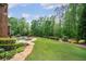 A beautiful backyard features a pool, patio, and lush greenery, perfect for outdoor entertaining at 5475 Copper Creek Pass, Cumming, GA 30040