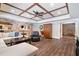 This finished basement features a coffered ceiling, brick accents, and a large sectional sofa at 5475 Copper Creek Pass, Cumming, GA 30040