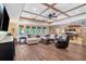 This finished basement features a coffered ceiling, a large sectional sofa, and brick accents at 5475 Copper Creek Pass, Cumming, GA 30040