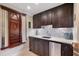 Wet bar featuring custom cabinetry, granite countertops, and under-counter refrigerator at 5475 Copper Creek Pass, Cumming, GA 30040