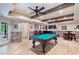 Basement entertainment space with pool table, bar, and access to the outdoor patio at 5475 Copper Creek Pass, Cumming, GA 30040