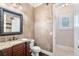 Elegant bathroom featuring granite counters, a vanity, toilet, and decorative wallpaper at 5475 Copper Creek Pass, Cumming, GA 30040