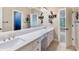 Bathroom with double vanity, large mirror, golf themed decor, and tiled floor at 5475 Copper Creek Pass, Cumming, GA 30040