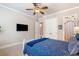 Comfortable bedroom featuring a ceiling fan, neutral walls, and carpet flooring at 5475 Copper Creek Pass, Cumming, GA 30040