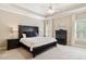 Carpeted bedroom features a ceiling fan, shuttered windows, and dark wood furniture at 5475 Copper Creek Pass, Cumming, GA 30040