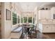 Cozy breakfast nook with bench seating, chandelier, and views to the backyard at 5475 Copper Creek Pass, Cumming, GA 30040