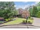 Charming two-story brick home with stone accents, covered front porch, and manicured landscaping at 5475 Copper Creek Pass, Cumming, GA 30040
