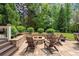 Cozy outdoor fire pit area with stone surround, patio, and comfortable seating for relaxing evenings at 5475 Copper Creek Pass, Cumming, GA 30040