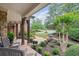 Cozy front porch with stone accents and view of the landscaped front yard at 5475 Copper Creek Pass, Cumming, GA 30040