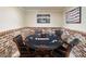 Game room with poker table, brick accents, decorative art and black leather chairs at 5475 Copper Creek Pass, Cumming, GA 30040