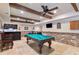 This basement game room features a pool table, brick accents, and a wet bar at 5475 Copper Creek Pass, Cumming, GA 30040