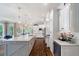 Bright kitchen features a large island, white cabinets, stainless steel appliances, and hardwood floors at 5475 Copper Creek Pass, Cumming, GA 30040