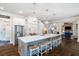 Spacious kitchen showcasing a large island with seating, stainless appliances, and hardwood floors at 5475 Copper Creek Pass, Cumming, GA 30040