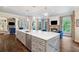 Open concept kitchen with expansive island, stone counters, and stainless steel appliances at 5475 Copper Creek Pass, Cumming, GA 30040
