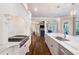 Elegant kitchen with stainless appliances and a view to the living area and outdoor space at 5475 Copper Creek Pass, Cumming, GA 30040