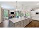 Open kitchen featuring a large island with seating and a view into the living room at 5475 Copper Creek Pass, Cumming, GA 30040