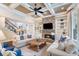 Elegant living room featuring coffered ceilings, a stone fireplace, and built-in bookshelves at 5475 Copper Creek Pass, Cumming, GA 30040