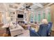 Cozy living room showcasing a stone fireplace, built-in shelving, and lots of natural light at 5475 Copper Creek Pass, Cumming, GA 30040
