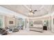 Spacious main bedroom with tray ceiling, sitting area, and many windows at 5475 Copper Creek Pass, Cumming, GA 30040