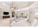 Large main bedroom featuring tray ceilings, a TV, and a comfortable sitting area at 5475 Copper Creek Pass, Cumming, GA 30040